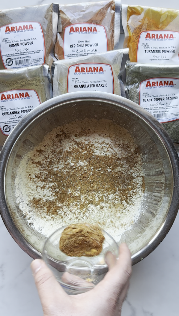 a bowl of chickpea flour and seasonings from Ariana Sweets for Afghan Pakawra